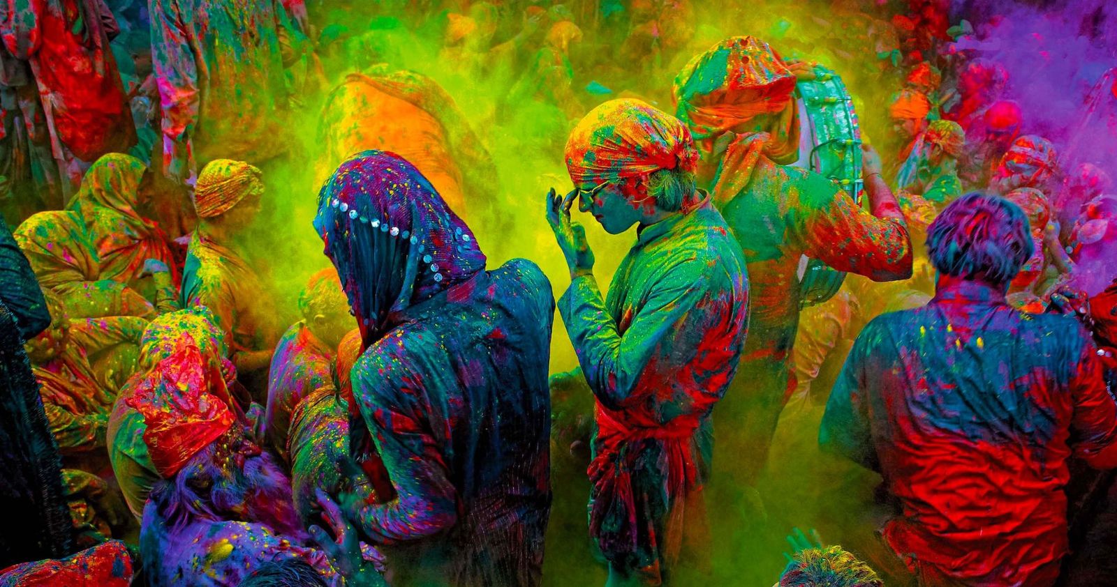 Revellers covered in vivid powder during a Holi celebration in India — cultural journeys with Travel Pals